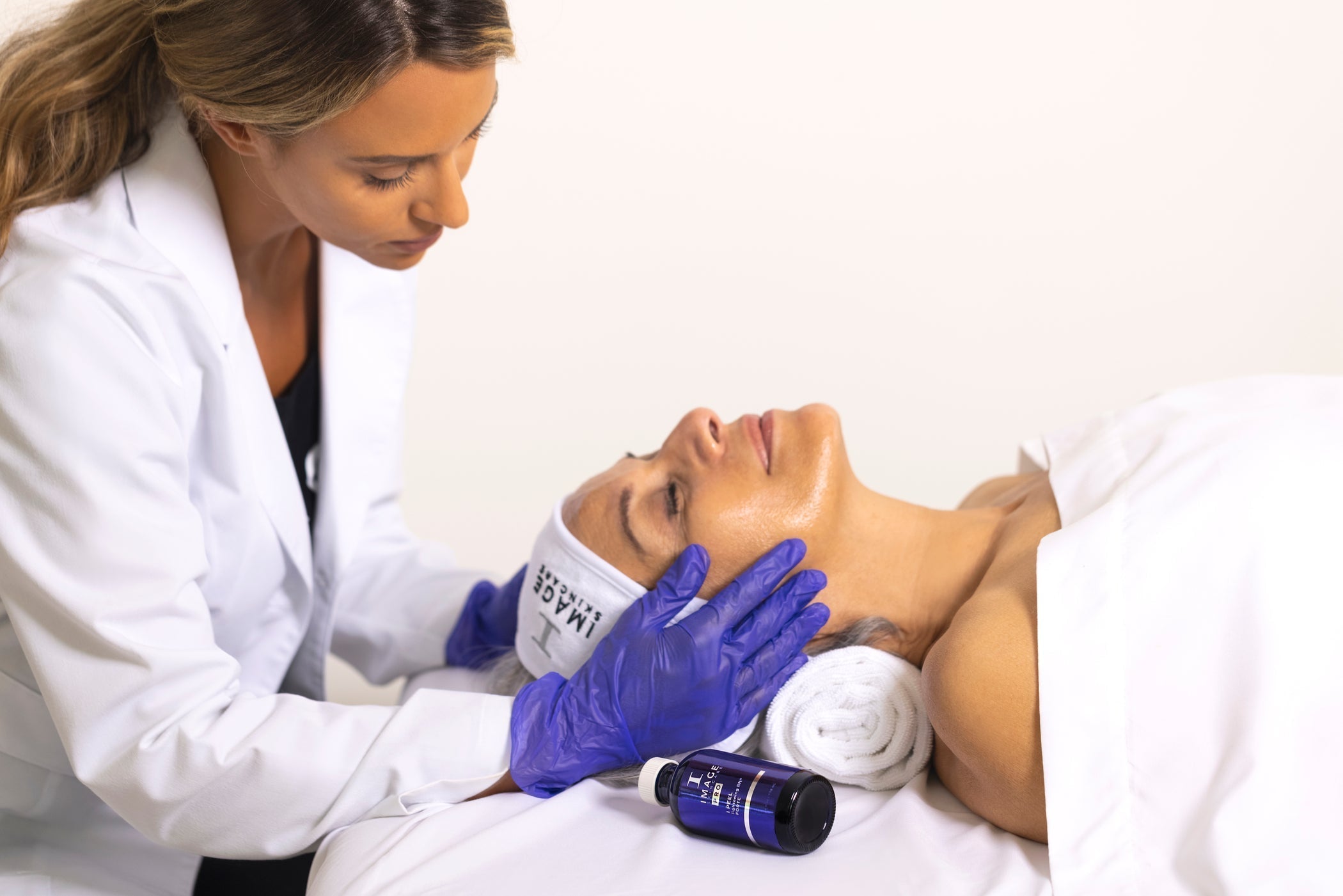 A woman receiving an IMAGE Skincare facial from her esthetician.