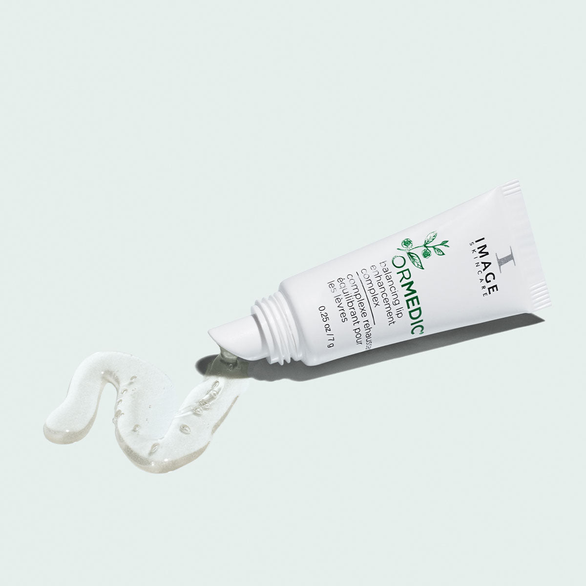 An open bottle of Image Skincare ORMEDIC lip treatment.